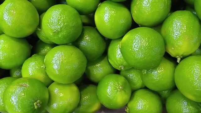 box of green lime tahiti, or taiti lemon (Citrus latifolia) in supermarket, exposed to the customer