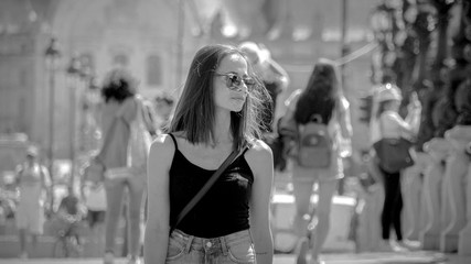 Fototapeta premium Young attractive woman walks over Alexandre III Bridge in Paris