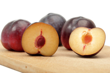 fresh plums on wooden table