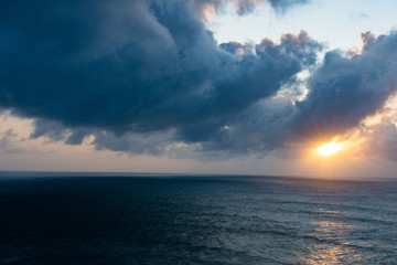 Heavy clouds during sunrise with wonderful steel looking sea