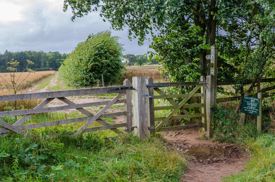 A gate in a wooden fence in the South Staffordshire countryside near the village of Perton, UK