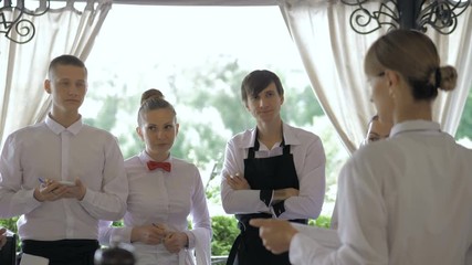 Restaurant manager and his staff in terrace. Interacting to head chef in restaurant