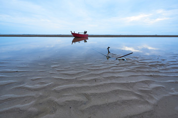 A red fisherman boat on the beach