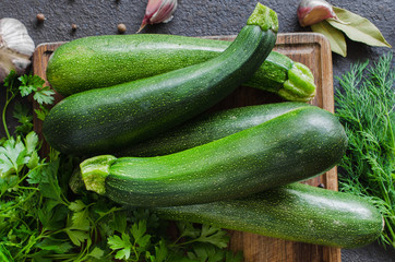 Fresh organic zucchini, garlic and parsley, herbs and spices.