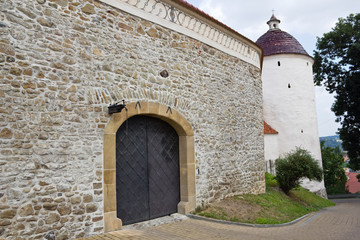 Fototapeta na wymiar Gate in Stone Wall. 13th Century. Monastery of the Poor Clares in the Stary Sacz. Poland.