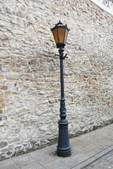 Street Light at Stone Wall Background. Monastery of the Poor Clares in the Stary Sacz, Poland.