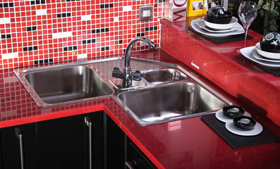 Black and red counter top in kitchen whit sink