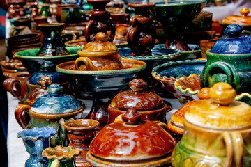 Colourful ceramics pots and dishes on the market, photo as background