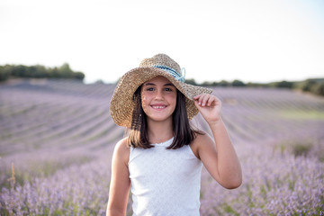 Pretty little girl in a field of lavender flowers