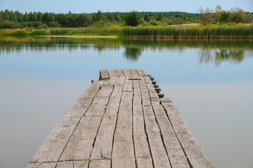 Empty old wooden bridge on a lake for meditation in Ukraine. Self-isolation concept.