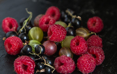 fresh organic berries on a black background