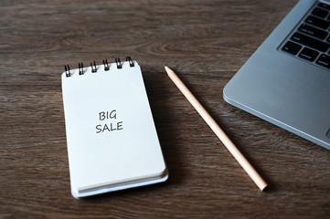 Big sale text With pencil and laptop computer,Business concept.