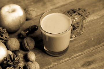 cup of coffee, heart shaped toy, nuts, cones and apples on the wonderful brown wooden background