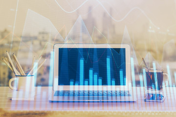 Stock market graph and table with computer background. Double exposure. Concept of financial analysis.