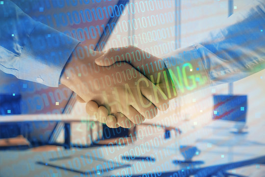 Double exposure of hacking theme hologram on office background with two men handshake. Concept of data security