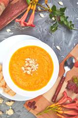 Cream of pumpkin soup on a gray background. Diet vegetarian