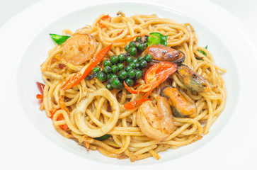 Spaghetti spicy with seafood on a white plate