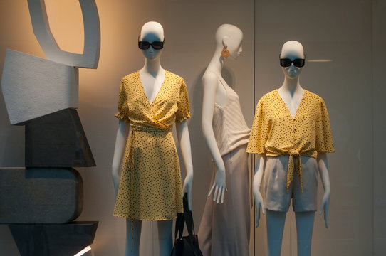 closeup of yellow summer clothes on mannequin  in women fashion store showroom