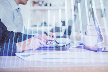 Forex graph with businessman working on computer in office on background. Concept of hardworking. Closeup. Multi exposure.