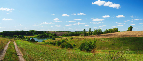 Beautiful panoramic view of country road,green hills and fields