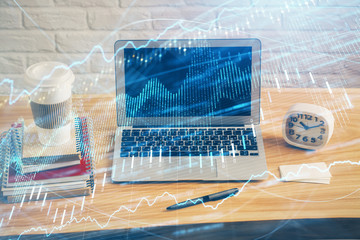 Double exposure of graph and financial info and work space with computer background. Concept of...