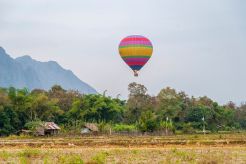 Hot air balloon above hut