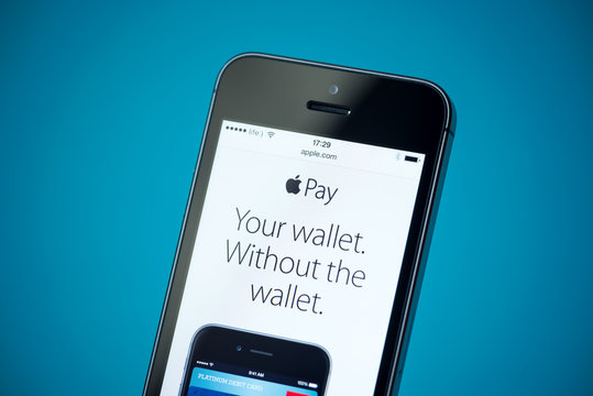 Kiev, Ukraine - September 24, 2014: Close-up shot of Apple iPhone 5S showing apple.com website with news announce of Apple Pay service.