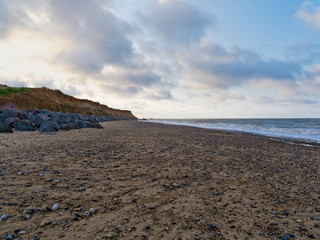 Large rocks help protect the fragile cliffs of Happisburgh beach from coastal erosion
