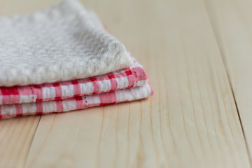stack of kitchen towels on light wooden background
