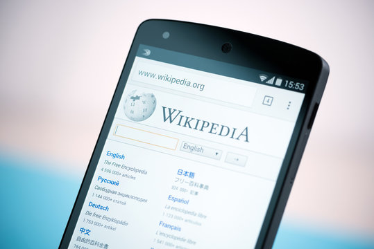 Kiev, Ukraine - September 22, 2014: Close-up shot of Google Nexus 5 smartphone, powered by Android 4.4 version, with the Wikipedia website homepage on a screen.