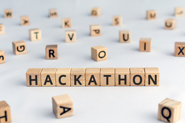 Hackathon - word from wooden blocks with letters, hackathon  hack day, hackfest or codefest event concept, random letters around, white  background © SecondSide