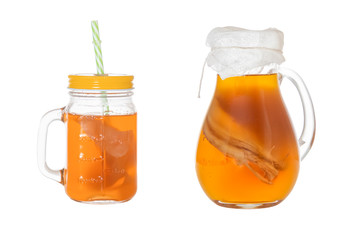 Homemade fermented drink Kombucha in a glass jug and jar. Isolated on white background