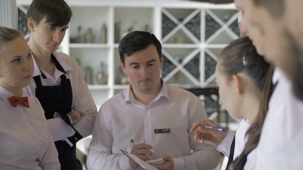 Briefing at the restaurant. Interacting to head manager in commercial kitchen