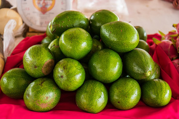 Group of fresh ripe and unripe avocados in the market.Thailand.