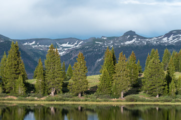 San Juan Mountains landscape of meadow, trees and snow-capped mountains in Colorado