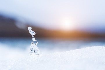 Ice on the frozen lake at sunset. Macro image, shallow depth of field. Winter nature background