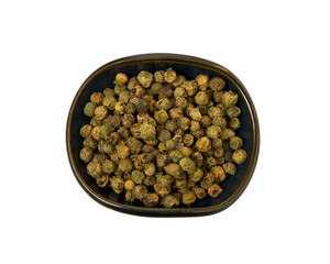 Green pepper in a bowl on isolate. View from above. Seasoning with peas of green pepper isolated on a white background. Close-up.
