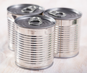 Three silver tin cans closeup