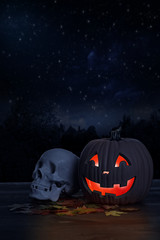 Glowing halloween pumpkin with human skull