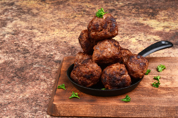 stack of meatballs in cast iron skillet