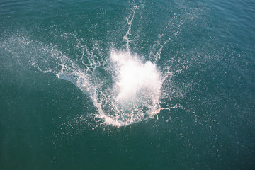 big splash in lake water view from above