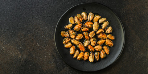 mussels in oil (delicious seafood) portion serving. top food background. copy space