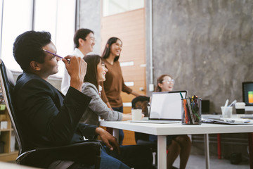 Group of happy Asian team creative business people laughing in meeting. teamwork concept © saksit