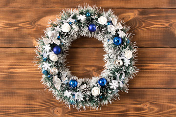Beautiful Christmas wreath on wooden background. The concept of Christmas