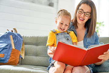 mother and daughter are reading a book.