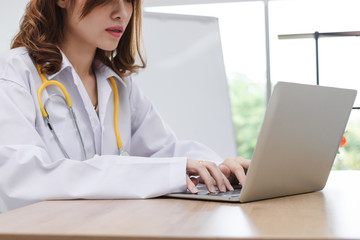 Medicine young Asian female doctor with laptop working in hospital office. Health care and medical concept.
