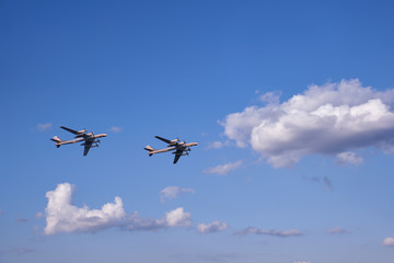 Fototapeta na wymiar Two propeller airplanes against clouds