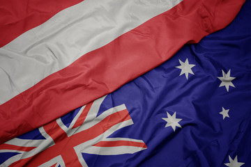 waving colorful flag of australia and national flag of austria.