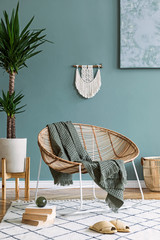 Boho interior design of living room with rattan armchair and macrame