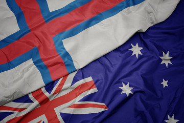 waving colorful flag of australia and national flag of faroe islands.